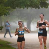 Two participants running through the event course